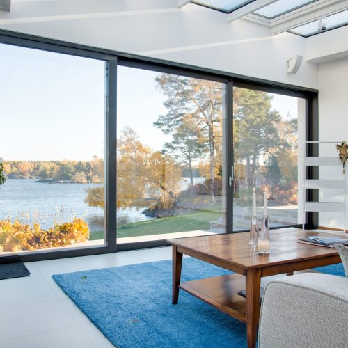 A beautiful view of a blue lake captured from the inside of a villa